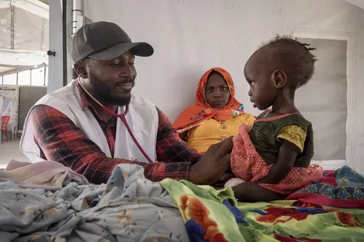 A doctor treats a Sudanese child suffering from malnutrition are treated at an MSF clinic in Metche Camp, Chad, near the Sudanese border, on April 6, 2024. (AP Photo/Patricia Simon, File)