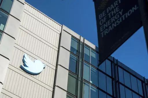 A Twitter logo hangs outside the company's San Francisco offices on Nov. 1, 2022. A top European Union official warned Elon Musk on Wednesday Nov. 30, 2022 that Twitter needs to beef up measures to protect users from hate speech, misinformation and other harmful content to avoid violating new rules that threaten tech giants with big fines or even a ban in the 27-nation bloc. (AP Photo/Noah Berger, File)