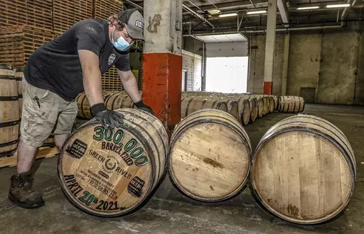 Green River Distilling Co. employee Coleman Savage looks over the 300,000th barrel of bourbon filled at the distillery inside the new-fill warehouse at the plant on April 20, 2021, in Owensboro, Ky. In the years it takes Kentucky bourbon to mature in new oak barrels, producers face two certainties: They lose a portion of the aging whiskey to evaporation and pay a tax on the containers. Now they are going to get relief from one of them. Kentucky’s legislature voted to completely phase out the p