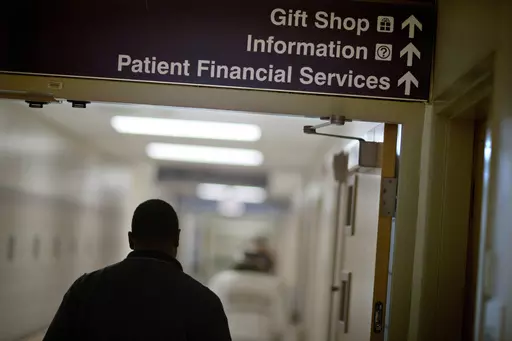 A sign points visitors toward the financial services department at a hospital, Friday, Jan. 24, 2014. Medicaid coverage will end for millions of Americans in 2023, and that pushes many into unfamiliar territory: the health insurance marketplace. (AP Photo/David Goldman, File)