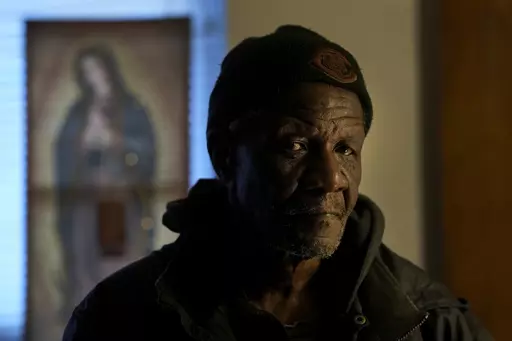 Rudolph Williams stands for a portrait in his apartment Monday, Jan. 8, 2024, in Harvey, Ill. Williams was home in the Chicago south suburb when he realized that the doors and windows to his courtyard-style apartment had been boarded up with plywood, locking him inside.(AP Photo/Charles Rex Arbogast)
