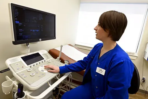Nurse Cassie Owen demonstrates an ultrasound machine at the Portico Crisis Pregnancy Center Jan. 26, 2022, in Murfreesboro, Tenn. States that have passed ever-restrictive abortion laws also have been funneling millions of taxpayer dollars into privately operated clinics that steer women away from abortions but provide little if any health care services. (AP Photo/Mark Zaleski)